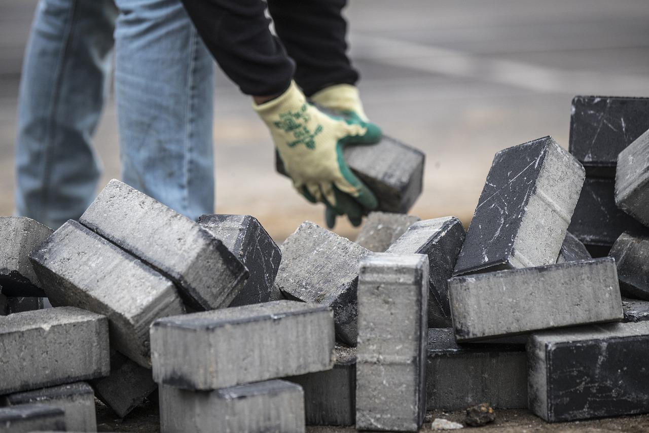 A stack of construction materials like pipes and metal sheets.